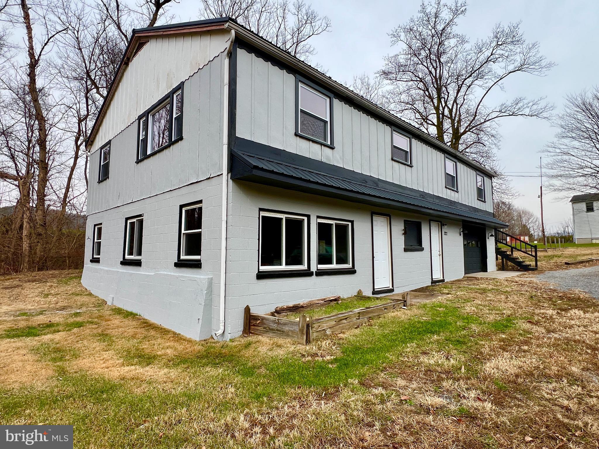 1722 Saxton Road Saxton, PA 16678 - Photo 7 of 24 a yellow house with trees in front of it