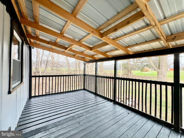 a view of hallway with wooden floor