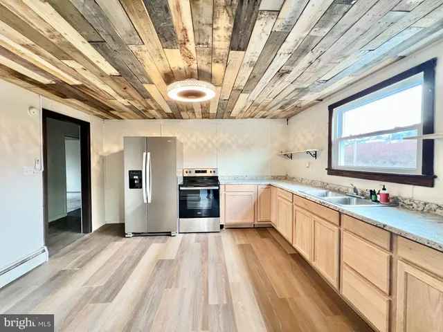 a large white kitchen with a large window