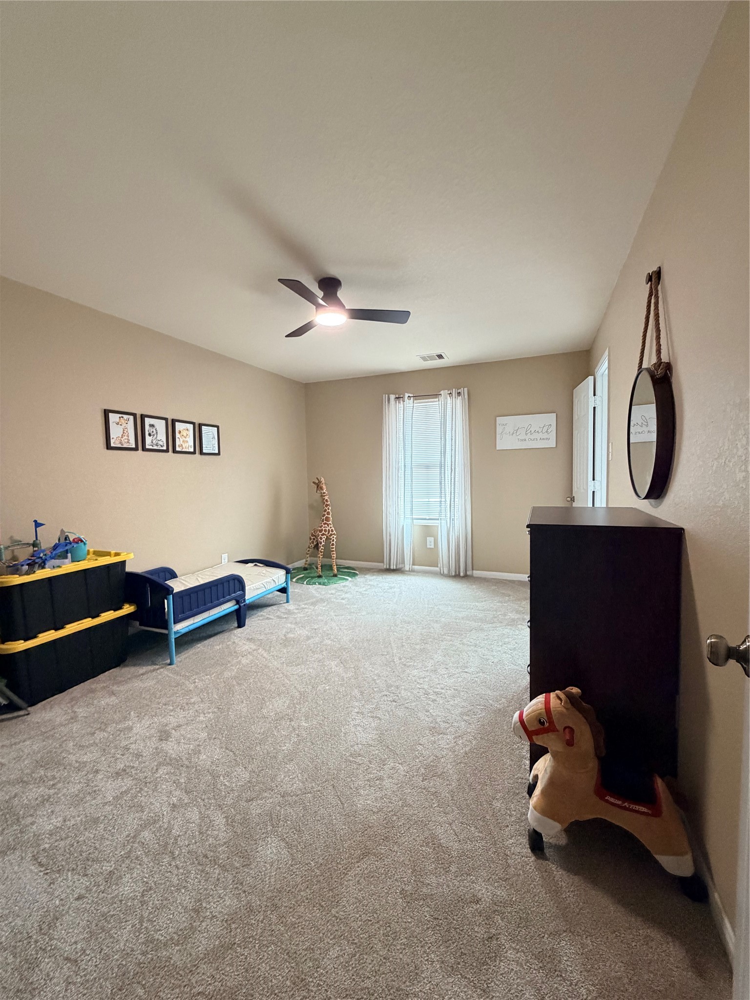 3226 Dappled Vale Trail Spring, TX 77373 - Photo 11 of 26 Cozy children's bedroom with neutral walls, carpeted floor, and a ceiling fan.