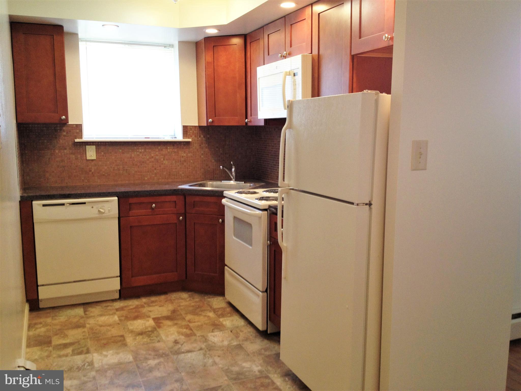 141 East 4th Avenue, Unit A1 Conshohocken, PA 19428 - Photo 2 of 10 a white refrigerator freezer sitting inside of a kitchen