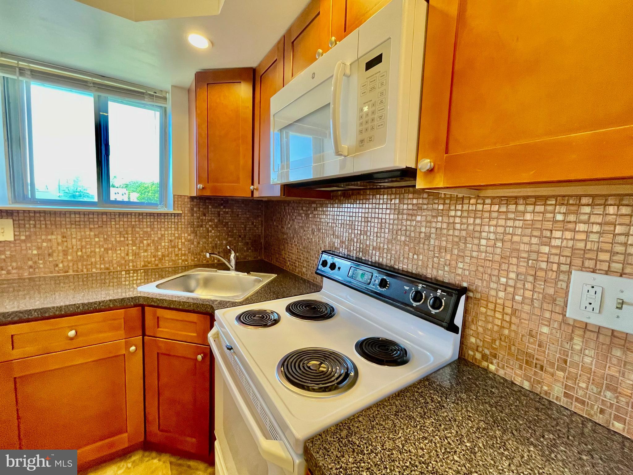 141 East 4th Avenue, Unit A1 Conshohocken, PA 19428 - Photo 4 of 10 a kitchen with a stove and cabinets