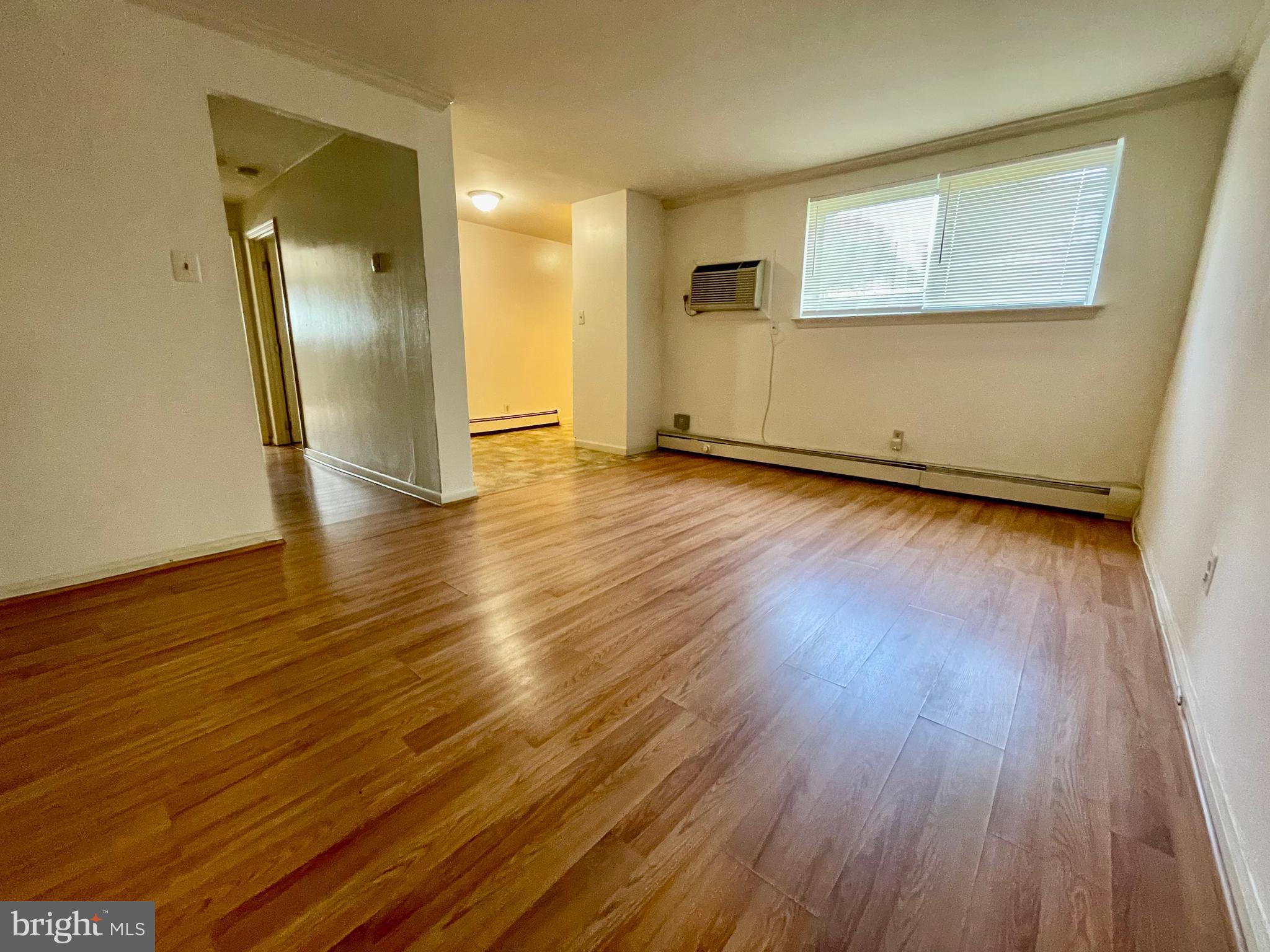 141 East 4th Avenue, Unit A1 Conshohocken, PA 19428 - Photo 6 of 10 an empty room with wooden floor and a window