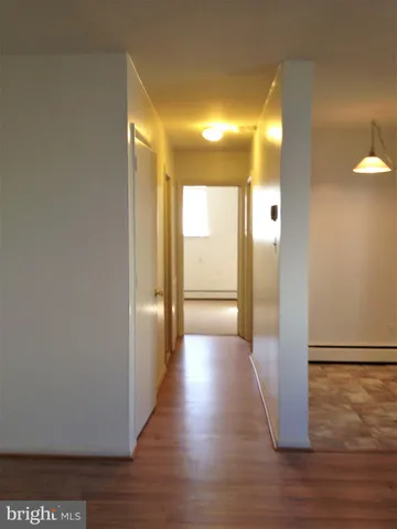 a view of a hallway with wooden floor