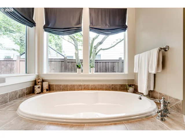 a white bath tub sitting next to a window
