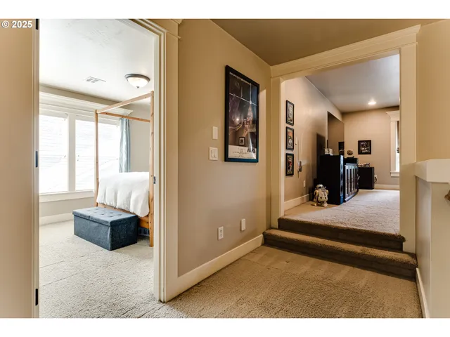 a living room with furniture and a hallway