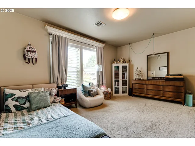 a bedroom with furniture and a window