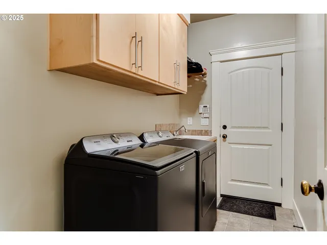 a utility room with sink dryer and washer