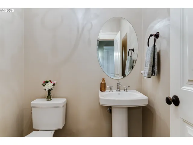 a bathroom with a sink a toilet and mirror