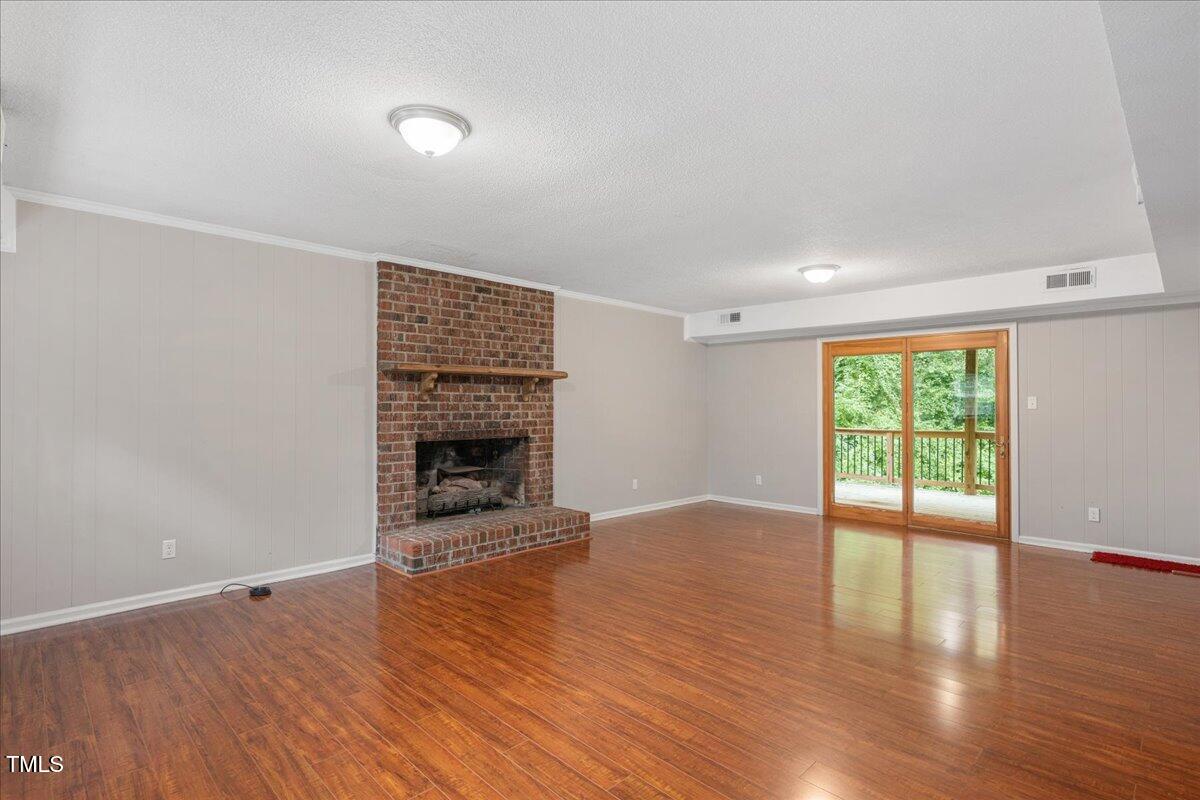 5812 Old Forge Circle Raleigh, NC 27609 - Photo 14 of 31 a view of an empty room with wooden floor and a window