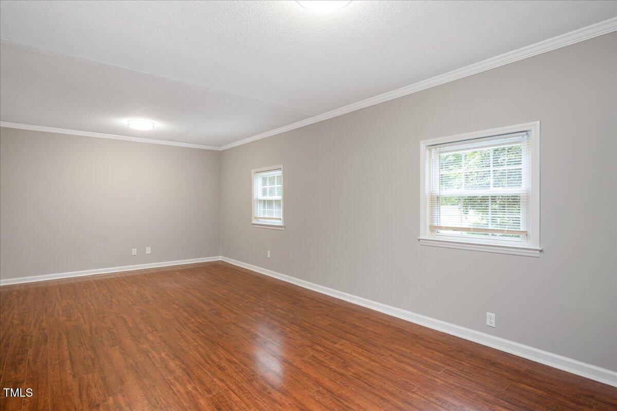 5812 Old Forge Circle Raleigh, NC 27609 - Photo 21 of 31 a view of an empty room with wooden floor and a window