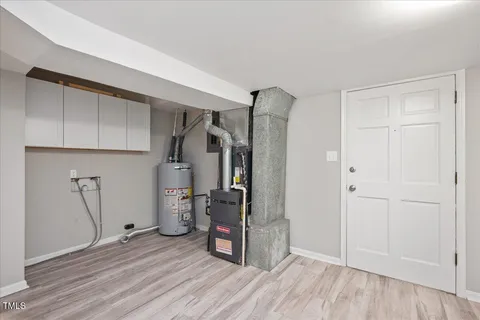 a view of empty room with wooden floor and ceiling fan
