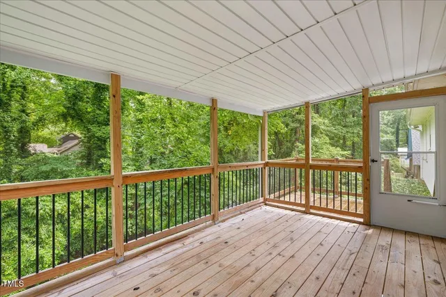 a view of a balcony with wooden floor