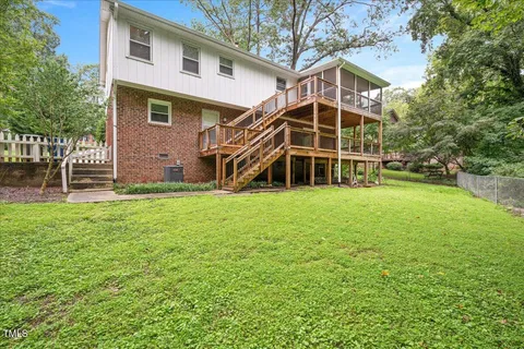 a view of a house with a yard and sitting area