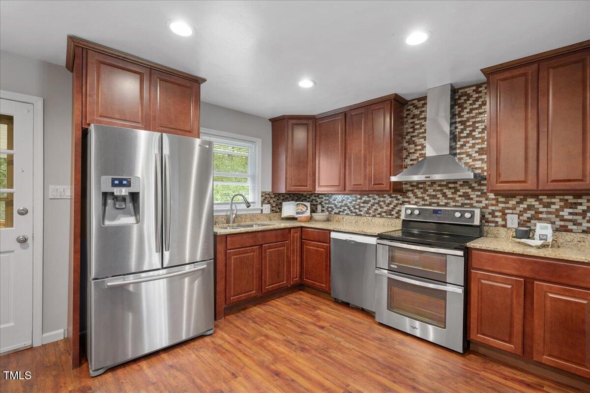 5812 Old Forge Circle Raleigh, NC 27609 - Photo 4 of 31 a kitchen with stainless steel appliances granite countertop a refrigerator stove and sink