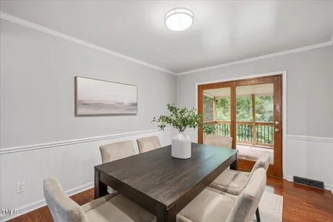 a view of a dining room with furniture window and wooden floor