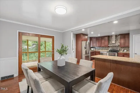a dining room with furniture and wooden floor