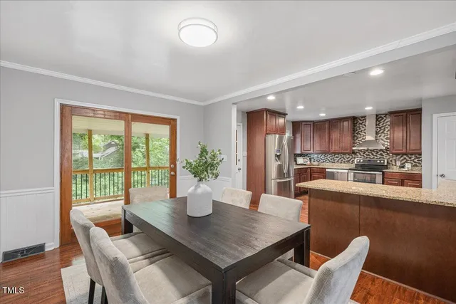 a dining room with furniture and wooden floor