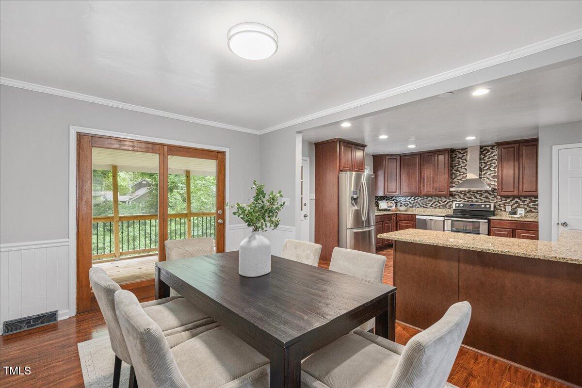 5812 Old Forge Circle Raleigh, NC 27609 - Photo 8 of 31 a dining room with furniture and wooden floor