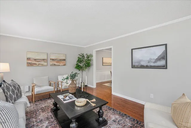 a living room with furniture and wooden floor