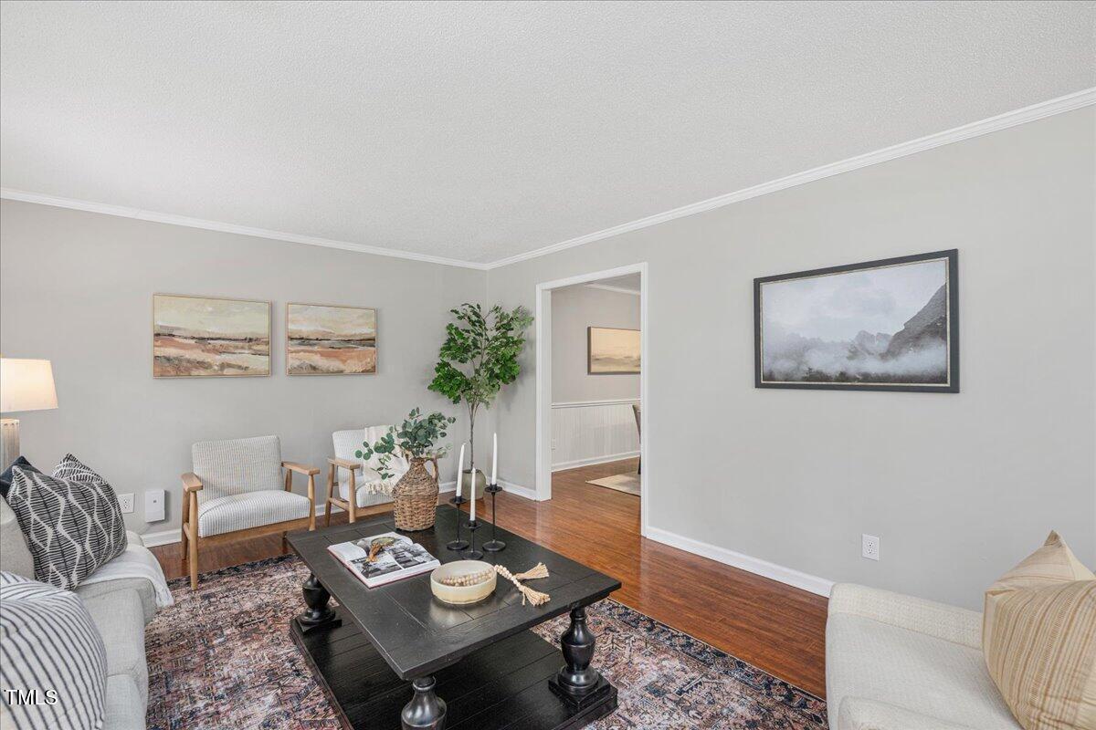 5812 Old Forge Circle Raleigh, NC 27609 - Photo 10 of 31 a living room with furniture and wooden floor