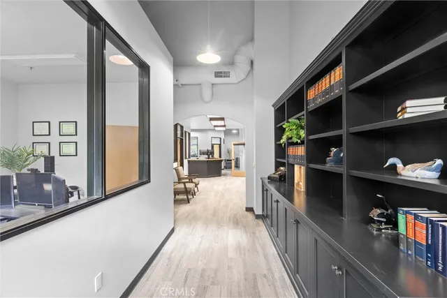 a view of a room with workspace and wooden floor