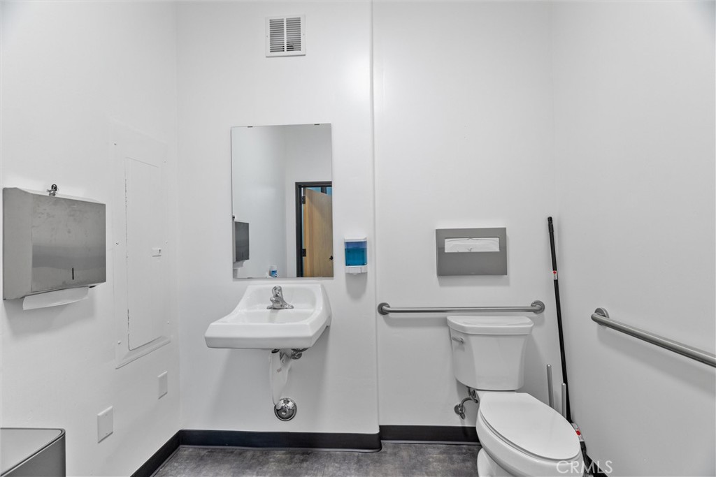 615 Clarion Court San Luis Obispo, CA 93401 - Photo 35 of 39 a bathroom with a sink toilet and mirror