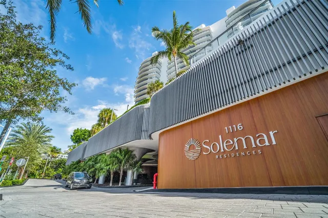 a view of kitchen with stainless steel appliances a sink and a refrigerator
