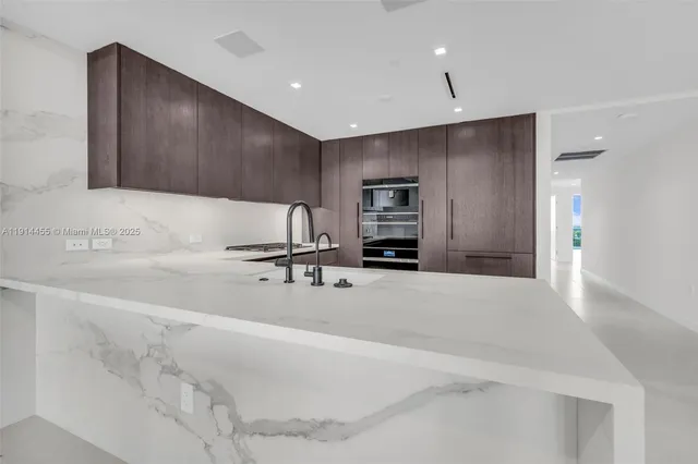 a stove top oven sitting inside of a kitchen
