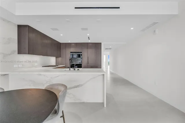 a spacious bedroom with a bed and large windows