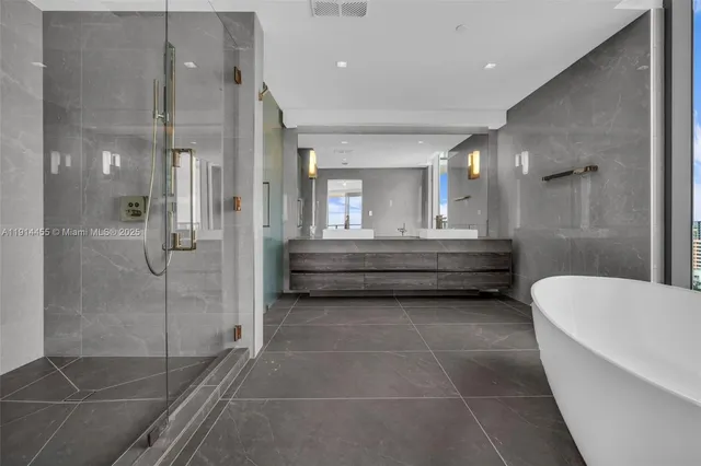 a living room with a couch and chandelier