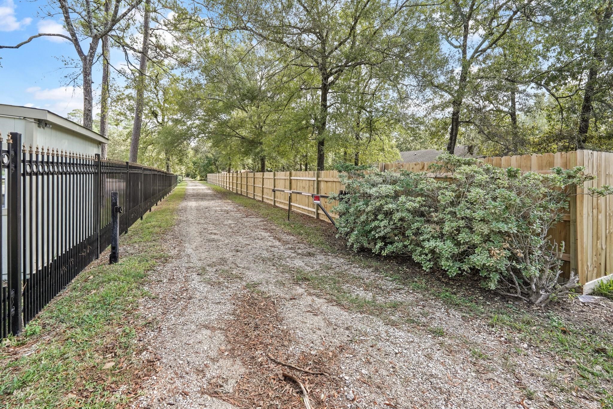 19410 Nehoc Lane Houston, TX 77346 - Photo 14 of 26 a view of a pathway of a yard with wooden fence