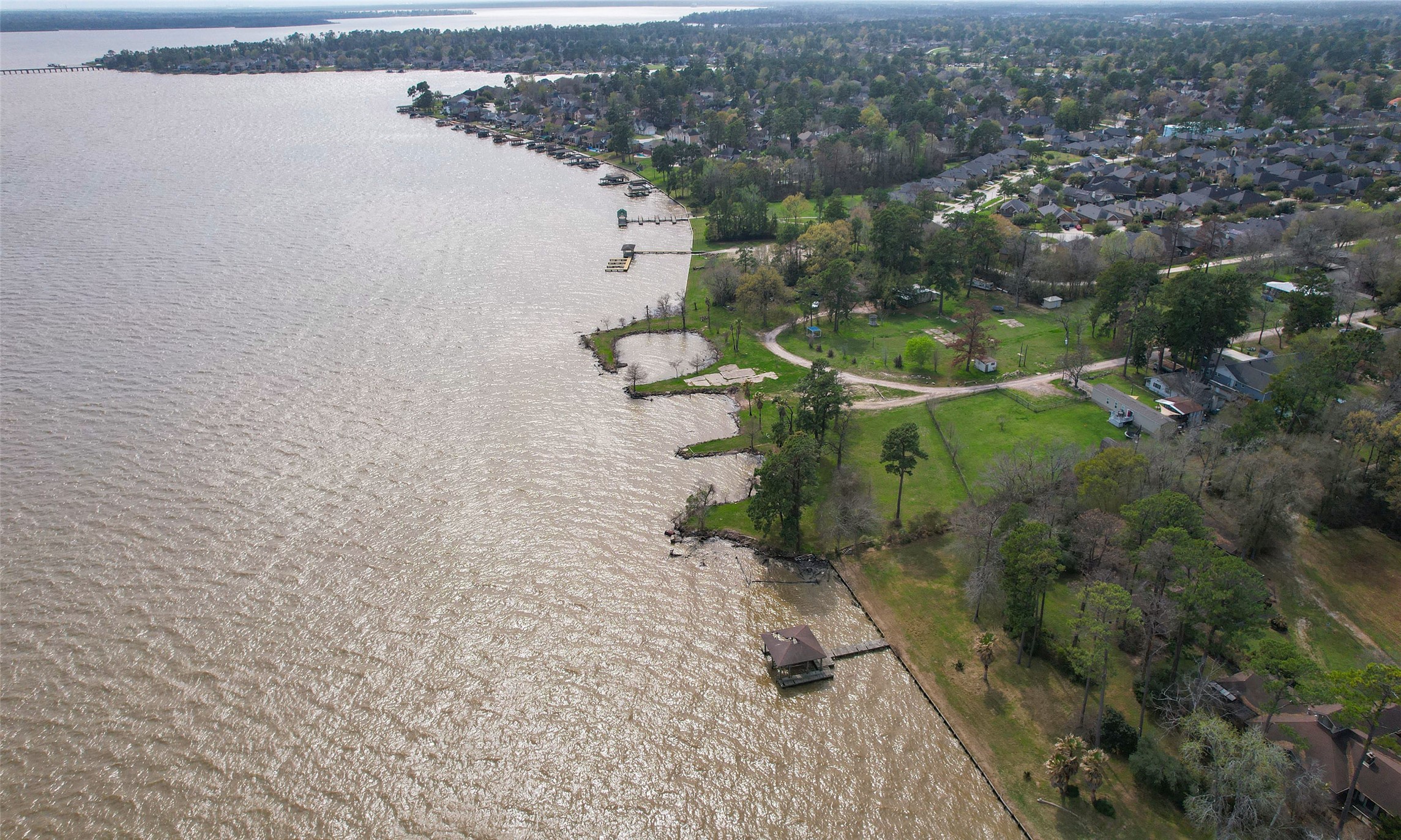19410 Nehoc Lane Houston, TX 77346 - Photo 19 of 26 an aerial view of a house with a yard and lake view