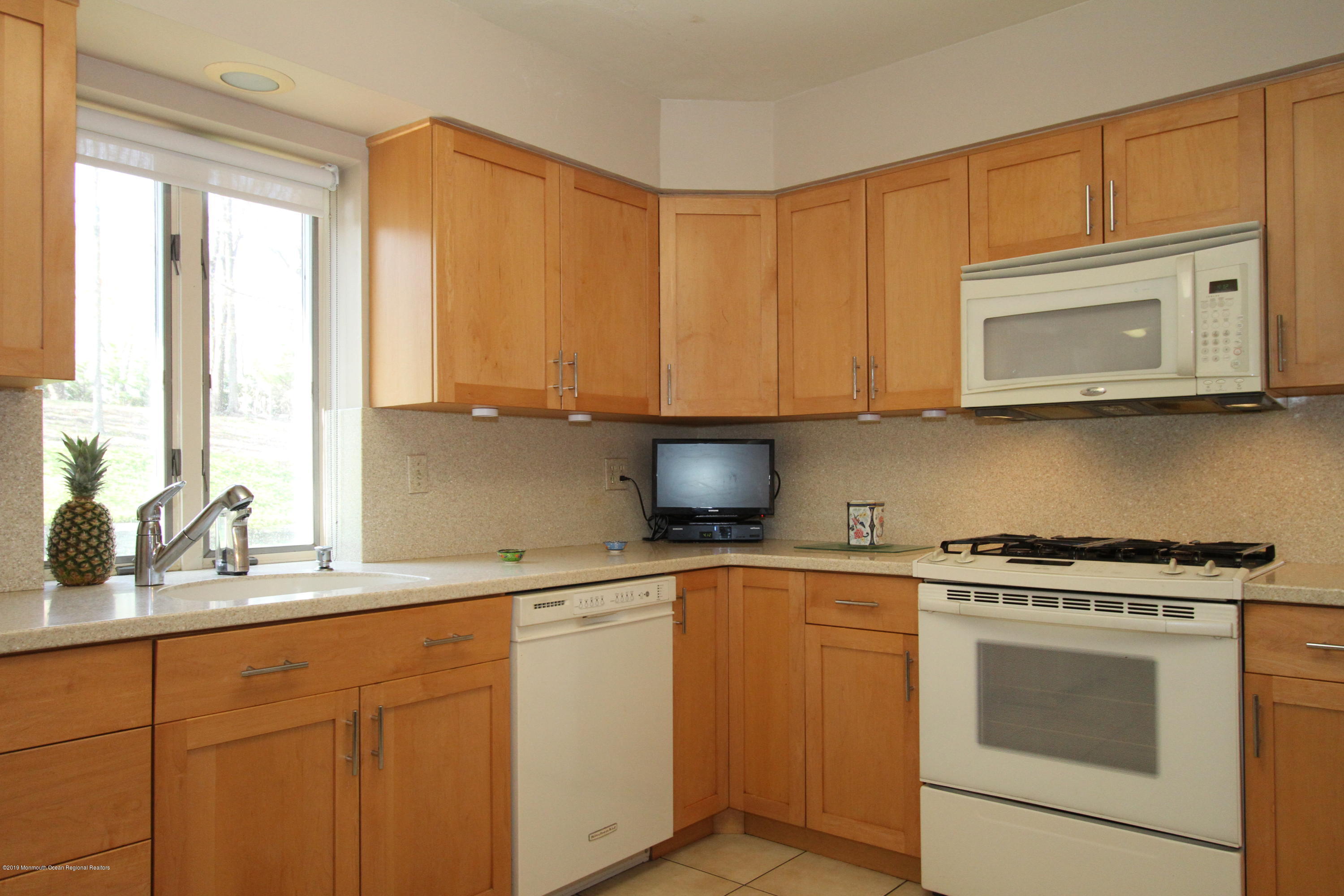3 Floyd Wyckoff Road Morganville, NJ 07751 - Photo 12 of 28 a kitchen with stainless steel appliances granite countertop a sink a stove and cabinets