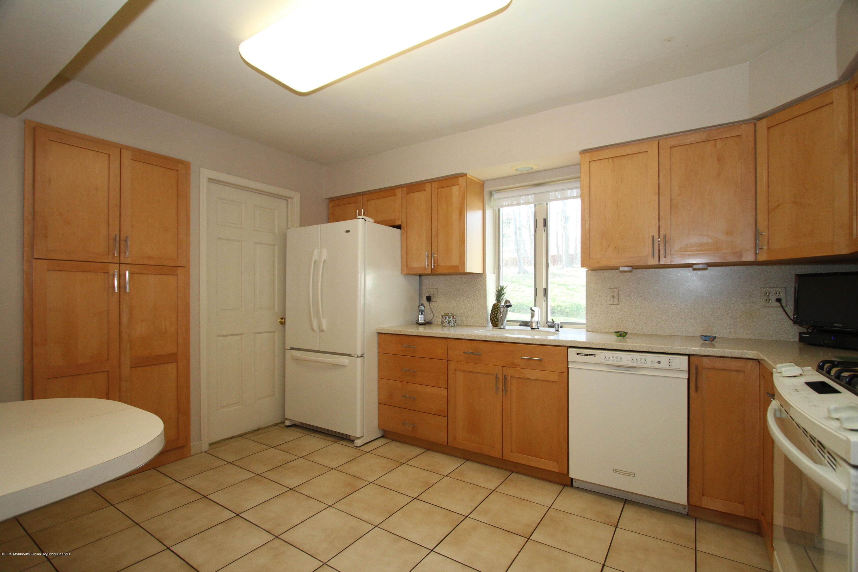 3 Floyd Wyckoff Road Morganville, NJ 07751 - Photo 13 of 28 a kitchen with a stove a sink and a refrigerator