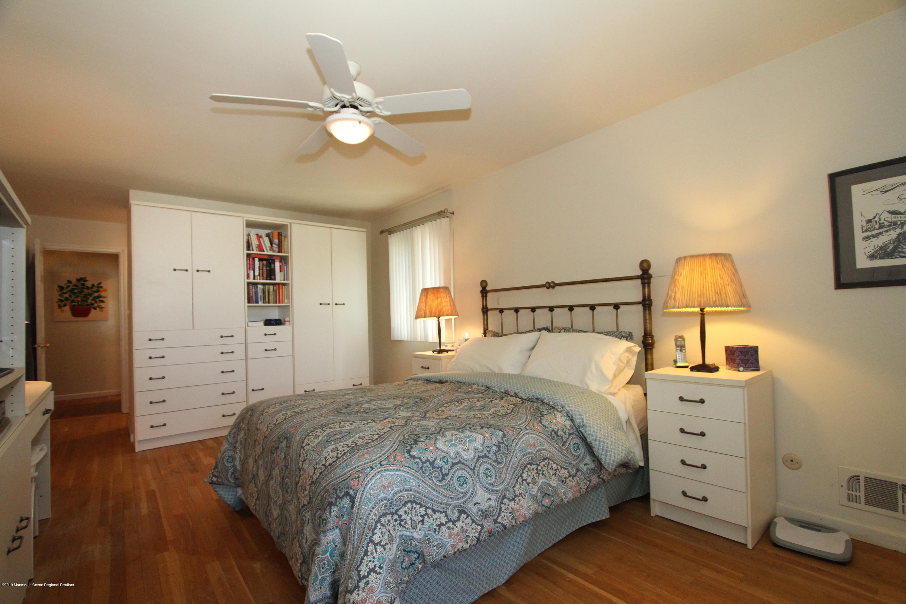 3 Floyd Wyckoff Road Morganville, NJ 07751 - Photo 17 of 28 a bedroom with a bed and a chandelier