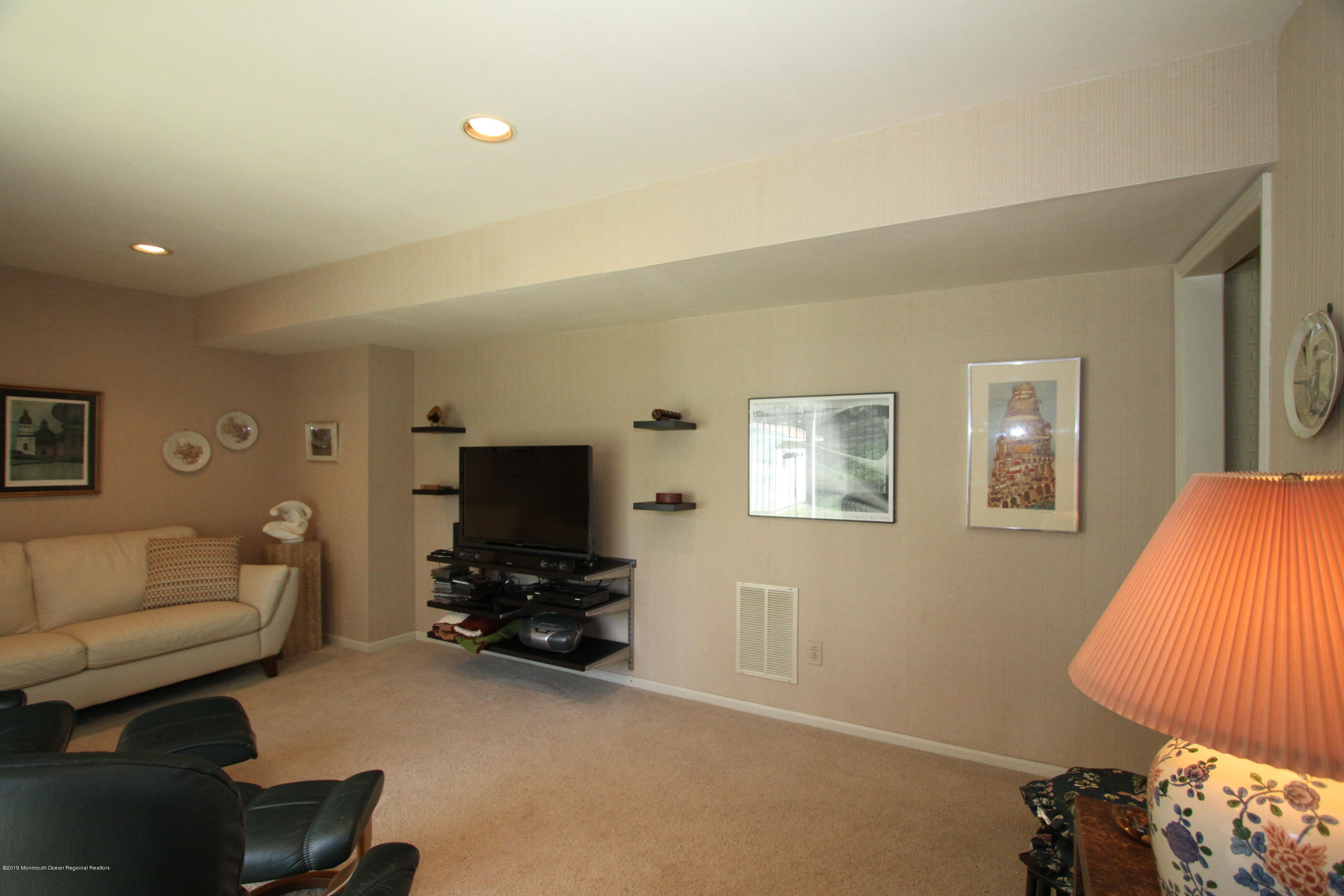 3 Floyd Wyckoff Road Morganville, NJ 07751 - Photo 19 of 28 a living room with furniture and a flat screen tv