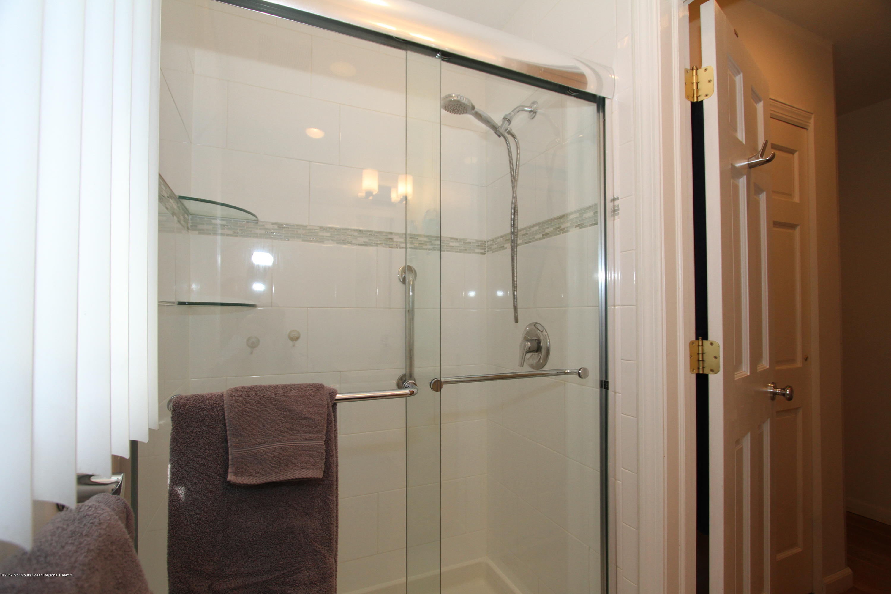 3 Floyd Wyckoff Road Morganville, NJ 07751 - Photo 24 of 28 a bathroom with a glass shower door