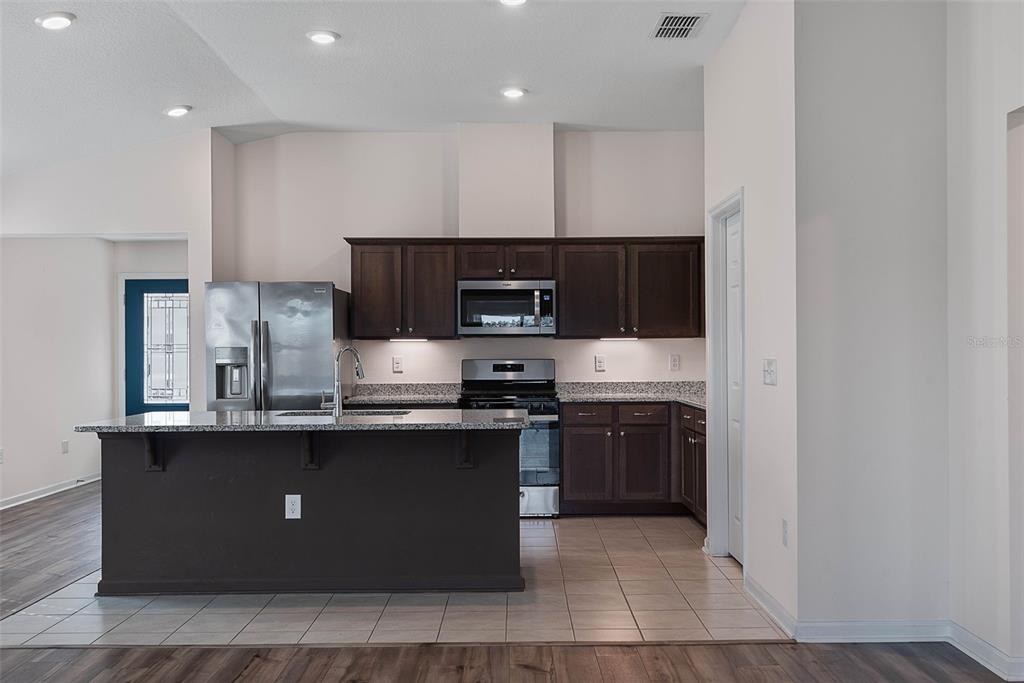 20 Willow Place Palm Coast, FL 32164 - Photo 11 of 61 a kitchen with stainless steel appliances granite countertop a stove a sink and a microwave
