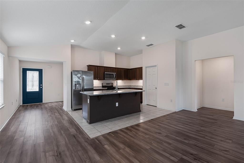20 Willow Place Palm Coast, FL 32164 - Photo 12 of 61 a large kitchen with wooden floors and wooden cabinets