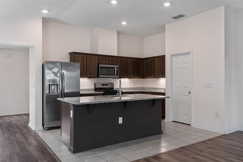 20 Willow Place Palm Coast, FL 32164 - Photo 13 of 61 a kitchen with stainless steel appliances granite countertop a sink a stove a refrigerator and cabinets