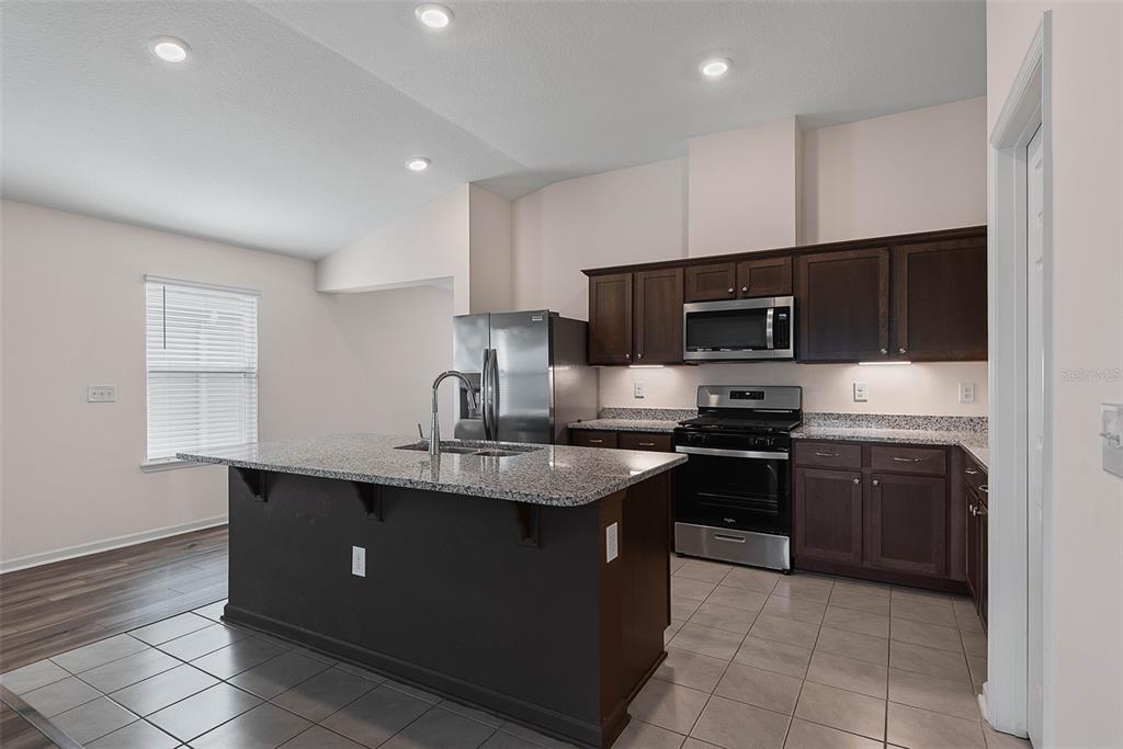 20 Willow Place Palm Coast, FL 32164 - Photo 14 of 61 a kitchen with stainless steel appliances granite countertop a sink dishwasher stove top oven and refrigerator
