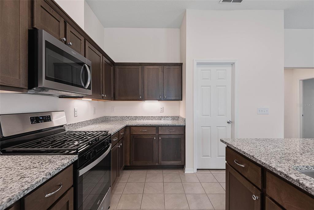 20 Willow Place Palm Coast, FL 32164 - Photo 17 of 61 a kitchen with stainless steel appliances granite countertop a stove microwave and sink