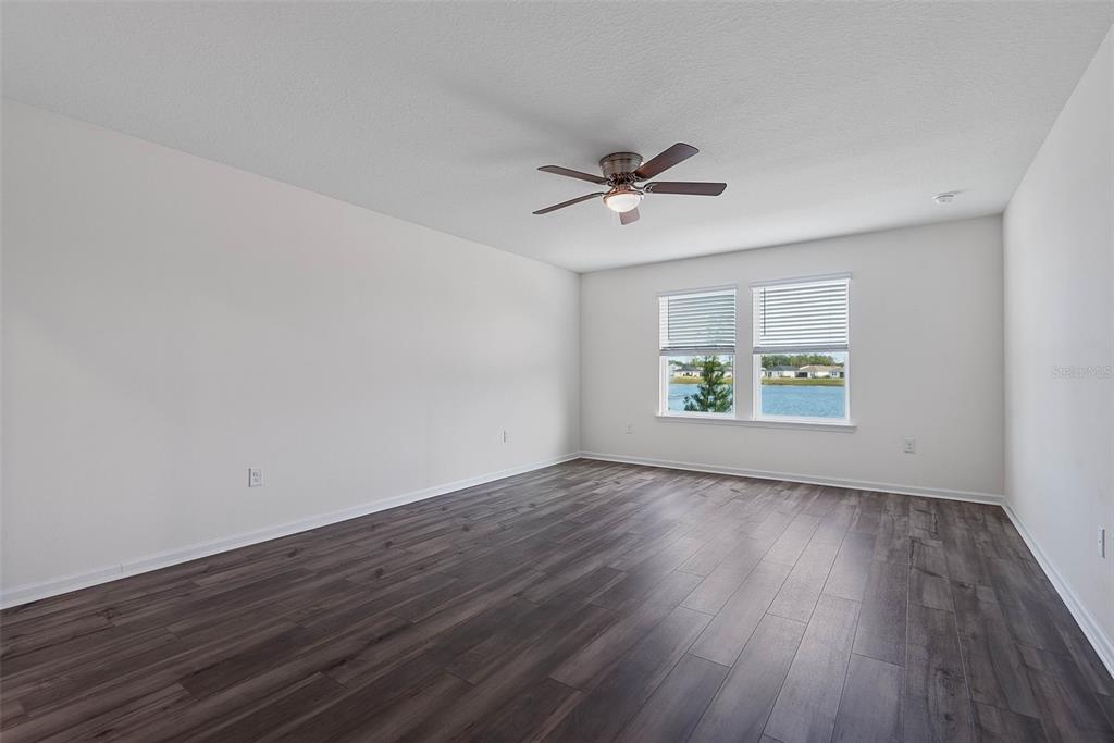 20 Willow Place Palm Coast, FL 32164 - Photo 20 of 61 an empty room with wooden floor and windows