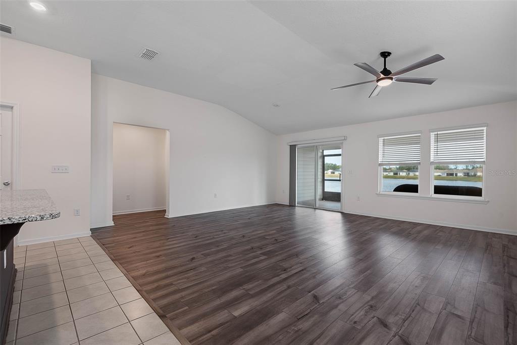 20 Willow Place Palm Coast, FL 32164 - Photo 6 of 61 a view of an empty room with window and wooden floor