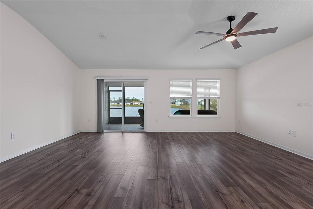 20 Willow Place Palm Coast, FL 32164 - Photo 7 of 61 an empty room with wooden floor and windows