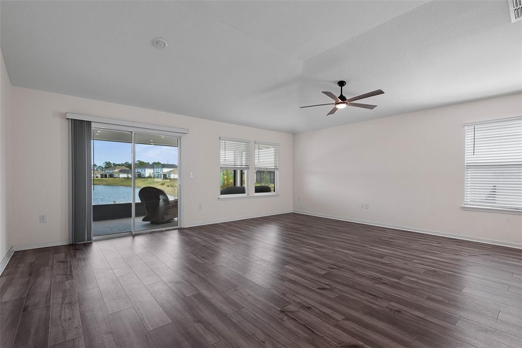 20 Willow Place Palm Coast, FL 32164 - Photo 8 of 61 a view of an empty room with a window and wooden floor