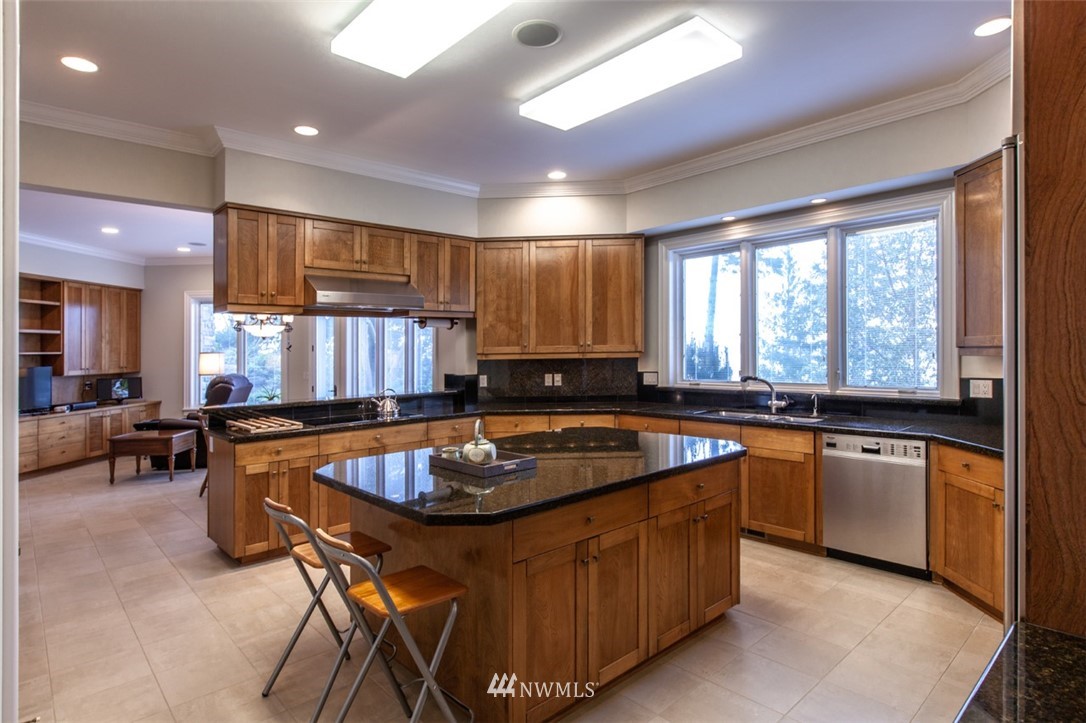 1334 Chuckanut Crest Drive Bellingham, WA 98229 - Photo 15 of 40 a kitchen with stainless steel appliances granite countertop a stove a sink a oven a dining table and chairs