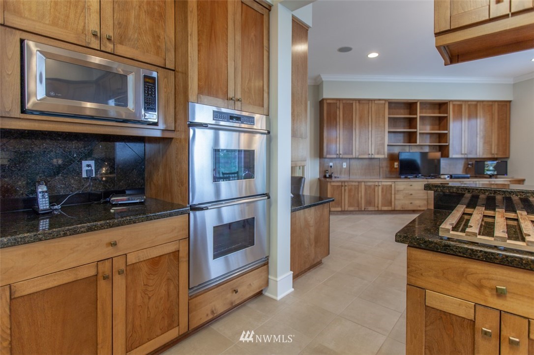 1334 Chuckanut Crest Drive Bellingham, WA 98229 - Photo 18 of 40 a kitchen with stainless steel appliances granite countertop a refrigerator a stove and a sink with wooden cabinets