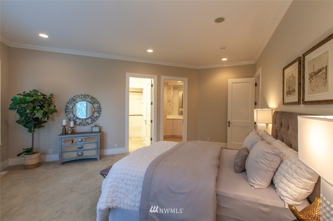 1334 Chuckanut Crest Drive Bellingham, WA 98229 - Photo 20 of 40 a bedroom with a bed and a chandelier